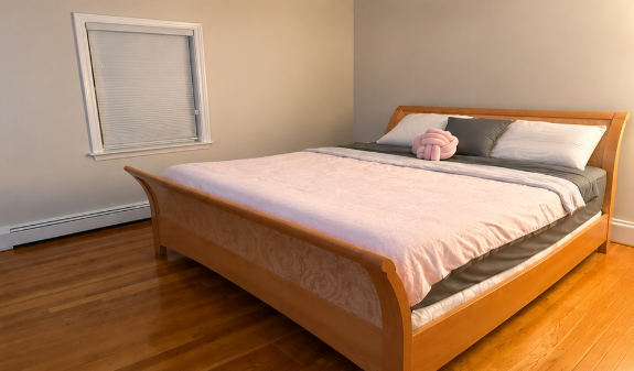 Clean bedroom with polished hardwood floors